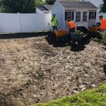 men landscaping a backyard