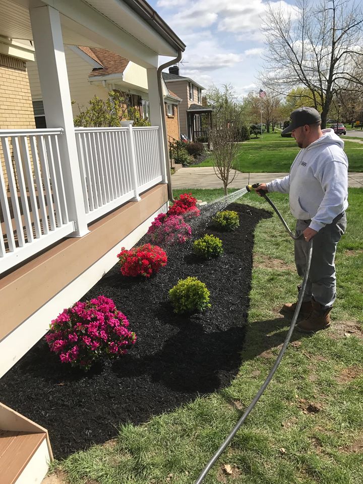 man watering garden