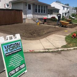 Vision Lawncare & Snowplowing working on front yard